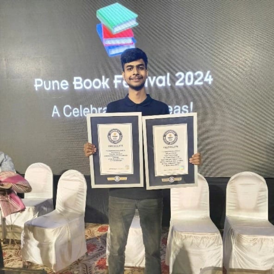 Srijan holding two Guinness World Records certificates at the Pune Book Festival